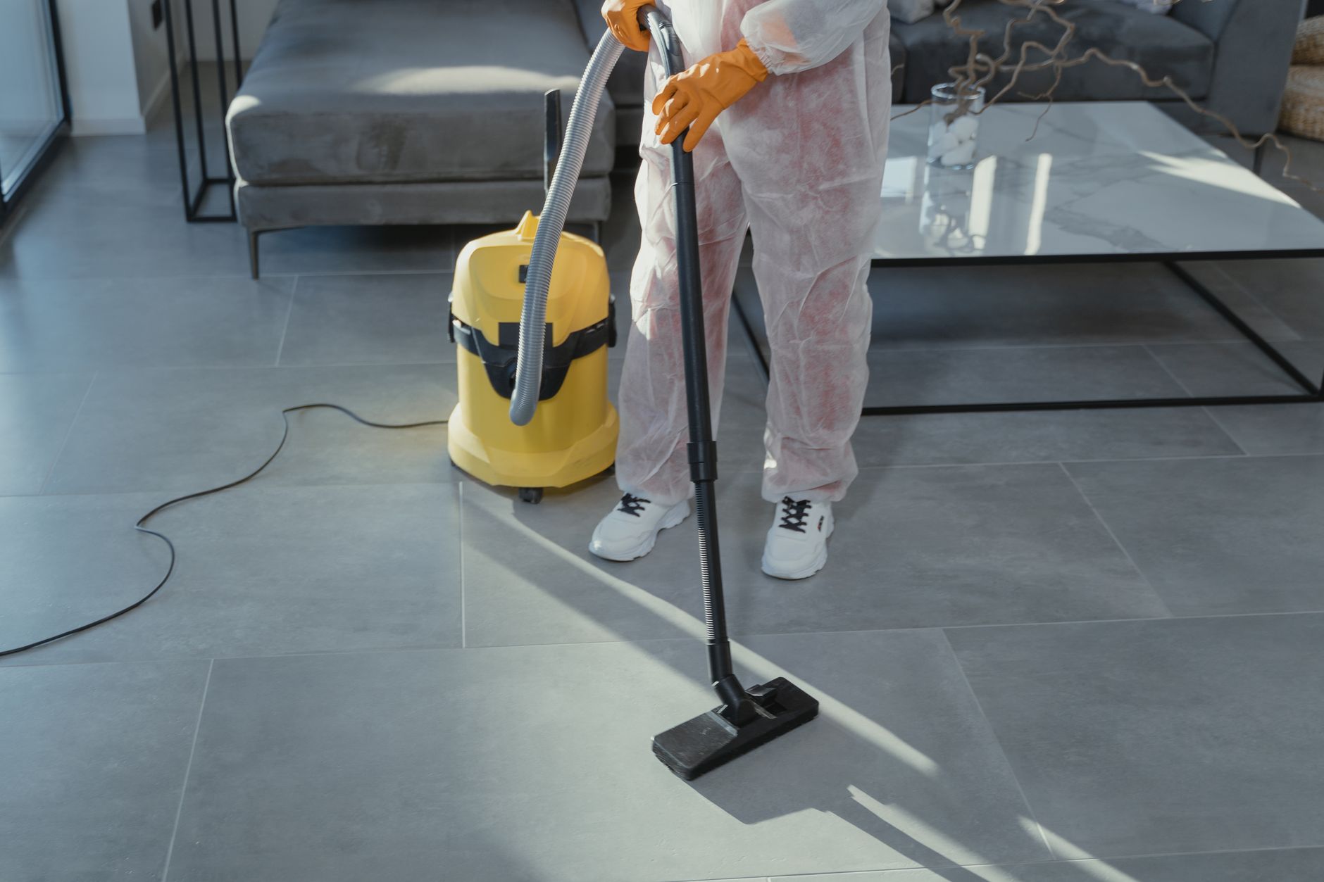A Blue Pro Mold Removal technician discussing a mold inspection report with a homeowner inside a clean, well-lit living room in Burkett, Texas.